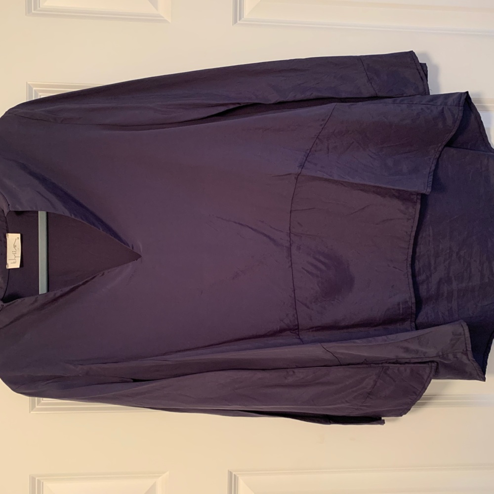 Women’s medium bell sleeve tunic style silk blouse with v neck.